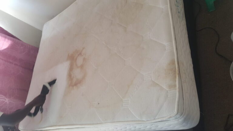 section of dirty mattress being cleaned